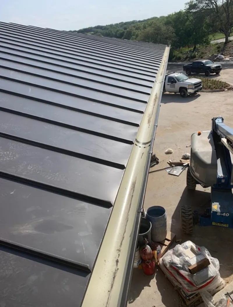 Standing seam panel and gutter detail on a metal roofing jobsite in Pico Rivera